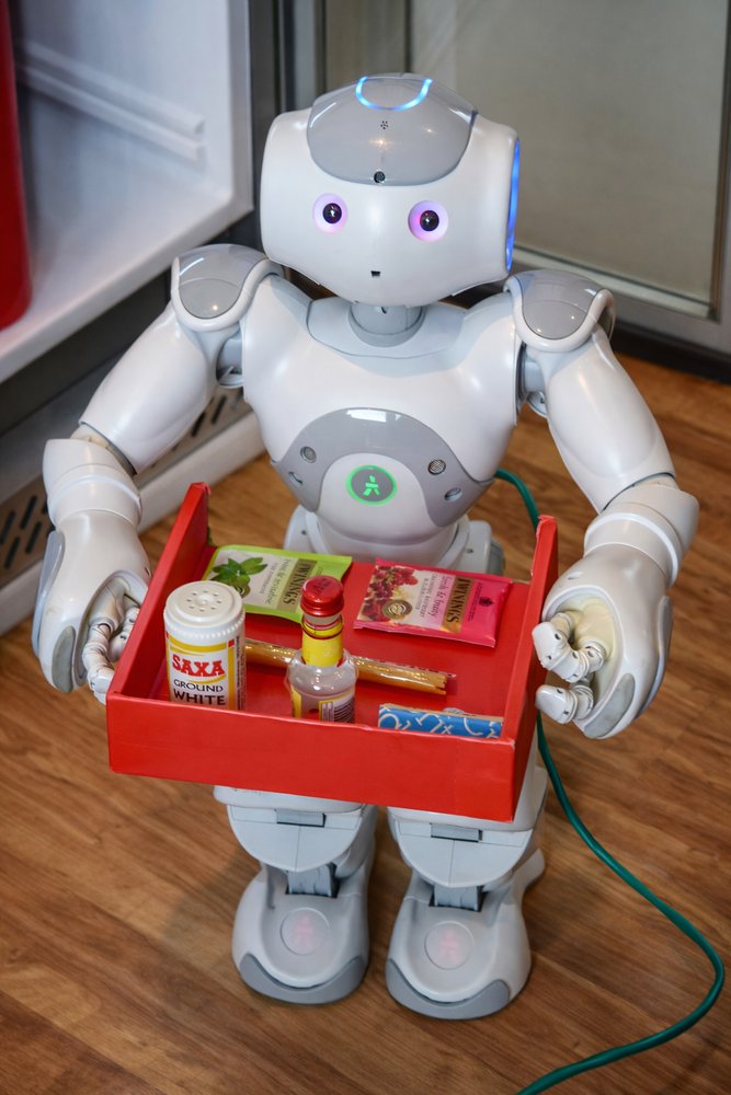 NAO humanoid robot holding a tray of ingredients for recipe recommendation research